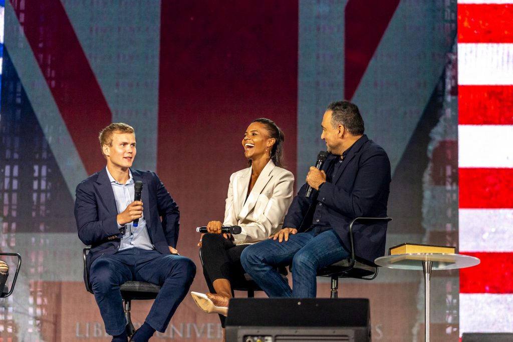Candace Owens Farmer on stage in front of the American flag